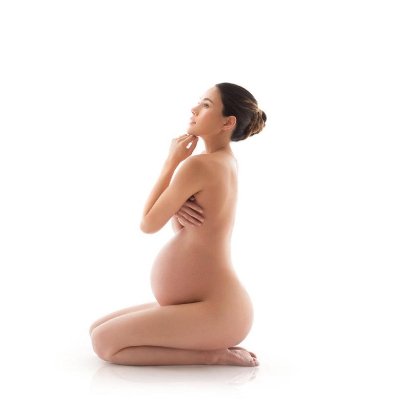 Naked pregnant women in bed, Studio photo shoot for pregnant women, Photo session of a naked pregnant woman