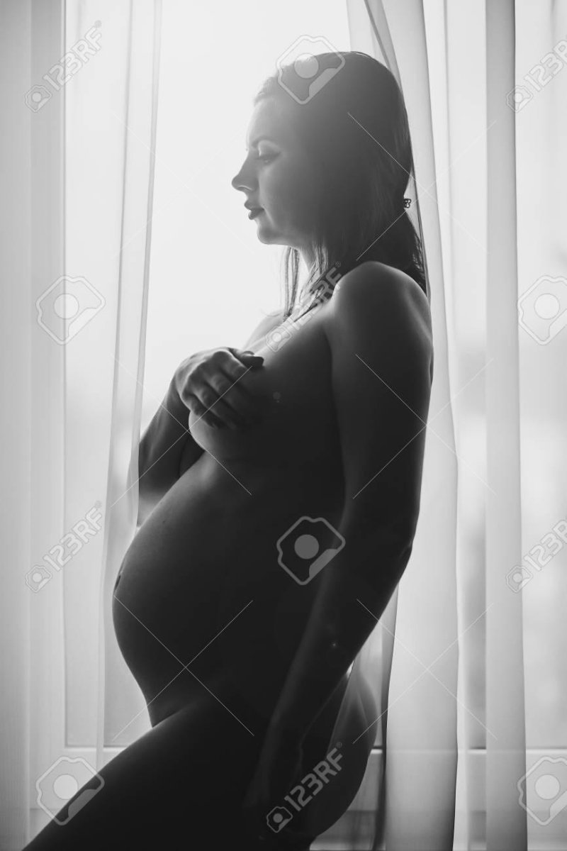 Photo session of a pregnant Nude, Beautiful pregnant, Pregnant woman on the side