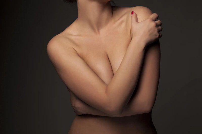 Girl covers her chest with hands, Girl covers her chest, Covers her chest with hand